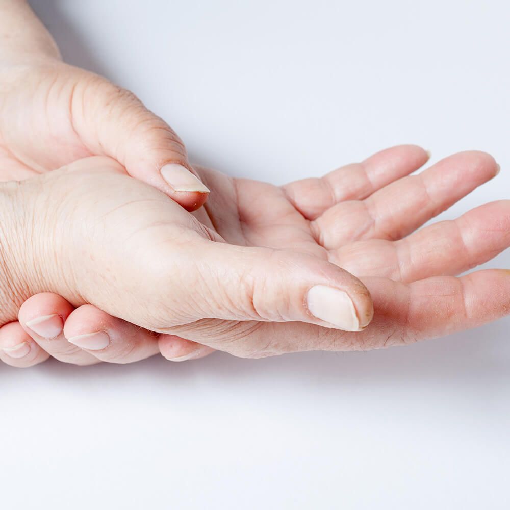 The left hand holds the right hand on a white background