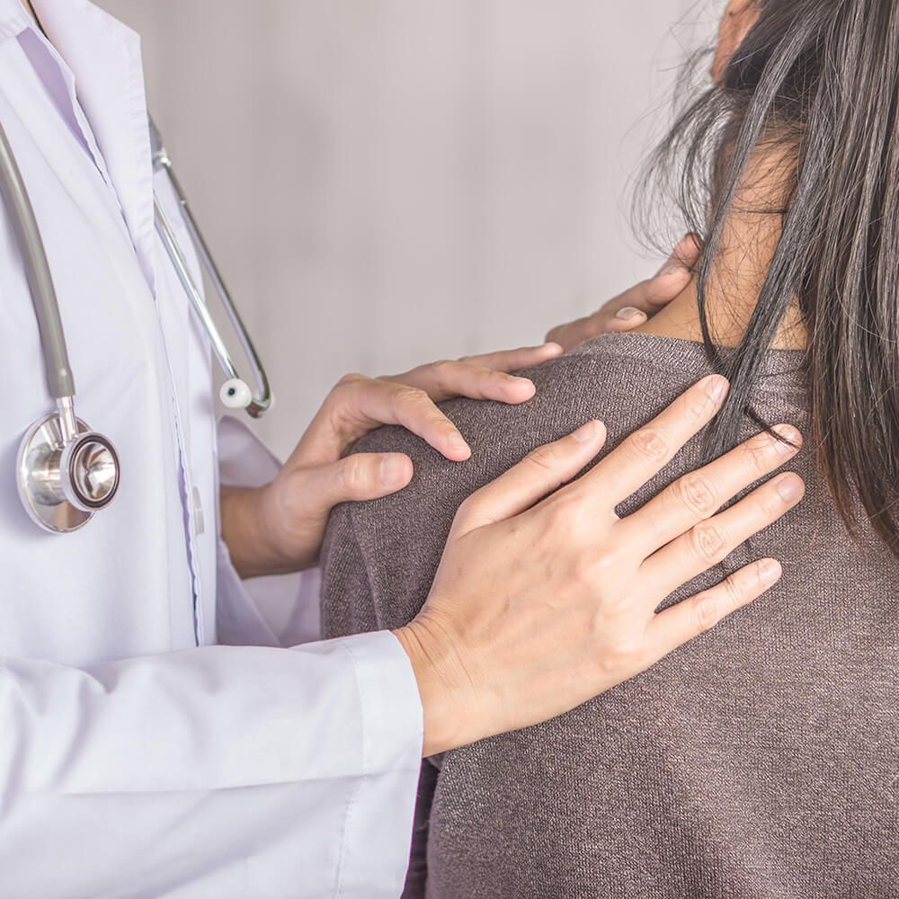 The doctor touches the patient's shoulder and back during the examination