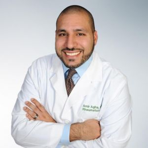 A doctor in a white coat. Amir Agha - Board Certified Rheumatologist